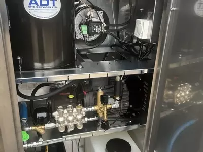 Internal view of a Nilfisk 400HS DTE system showing pump, burner, pipework, and chemical setup after installation and modifications. Clean, organised layout designed for reliability and ease of servicing.